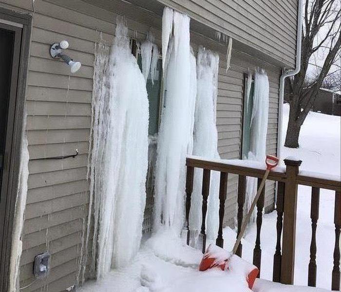 Frozen water leaking from a home.